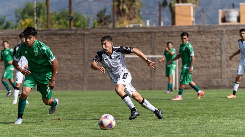 Dynamic scene of a soccer match showcasing players in motion on a sunny day.